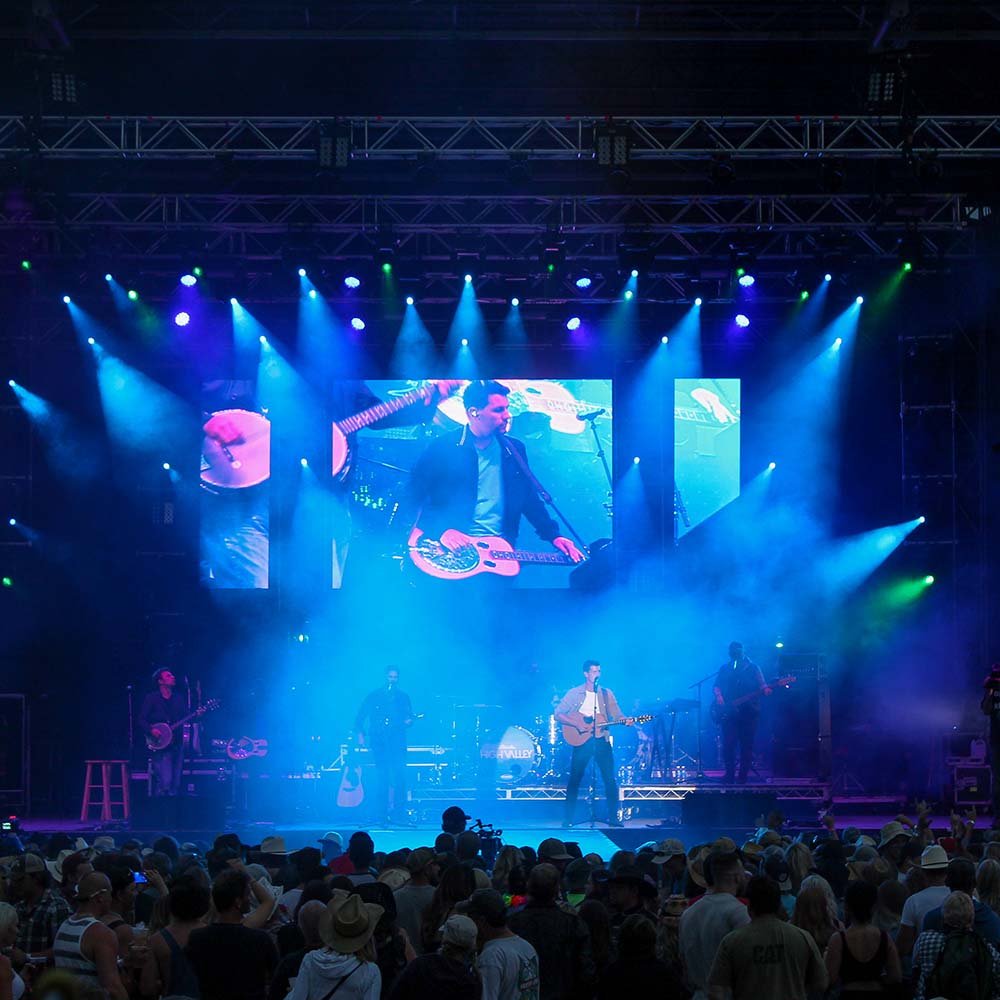 Man plays guitar on concert stage